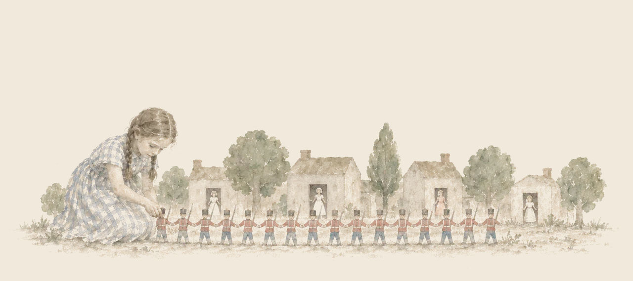 Dorothy kneels beside a line of paper soldiers holding hands, in front of a row of cardboard houses with paper dolls in the doorways.