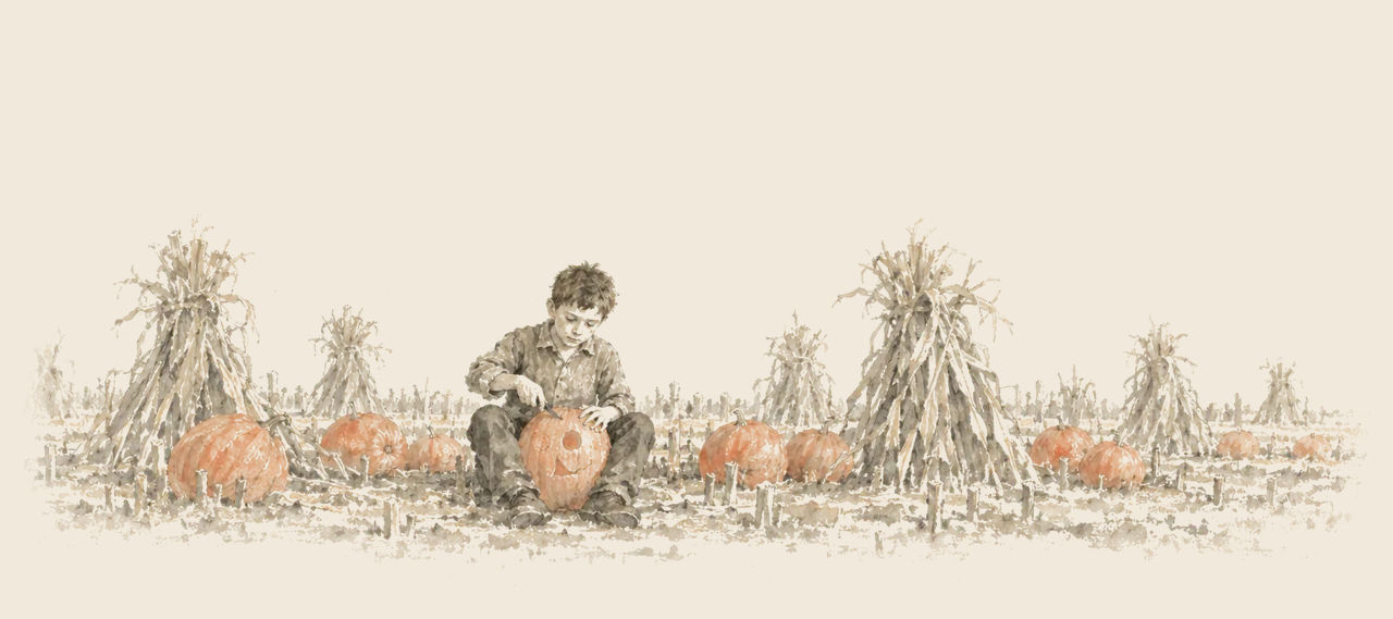 Tip sits among pumpkins and cornshocks in a cut cornfield, carving a face into a big pumpkin held between his knees.