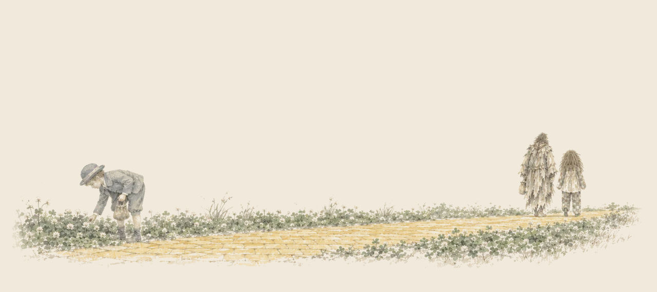 Ojo bends over the clover at the roadside with his basket, while far ahead the Shaggy Man and the Patchwork Girl walk away along the yellow brick road.